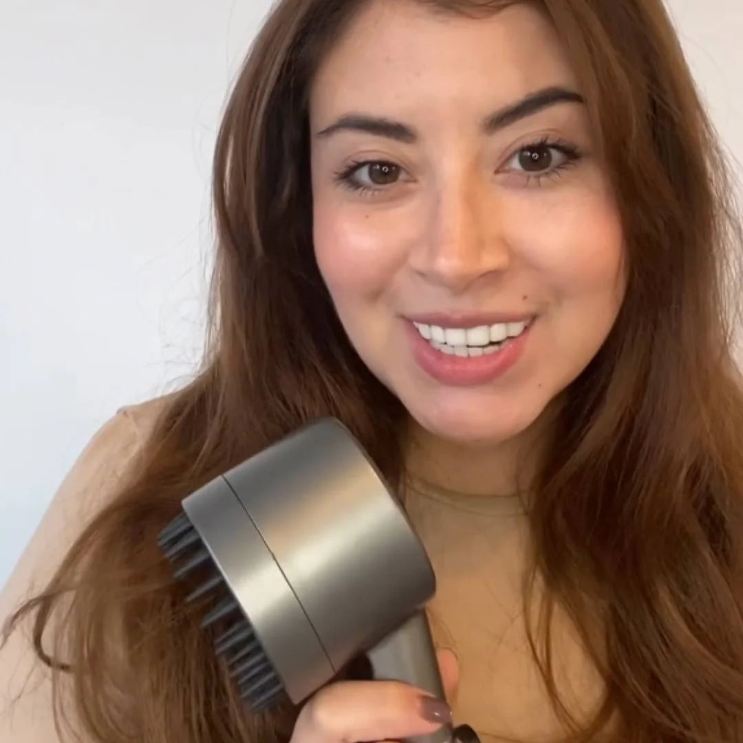 Smiling woman holding the FlowMist high-pressure filtered showerhead while giving a video testimonial.