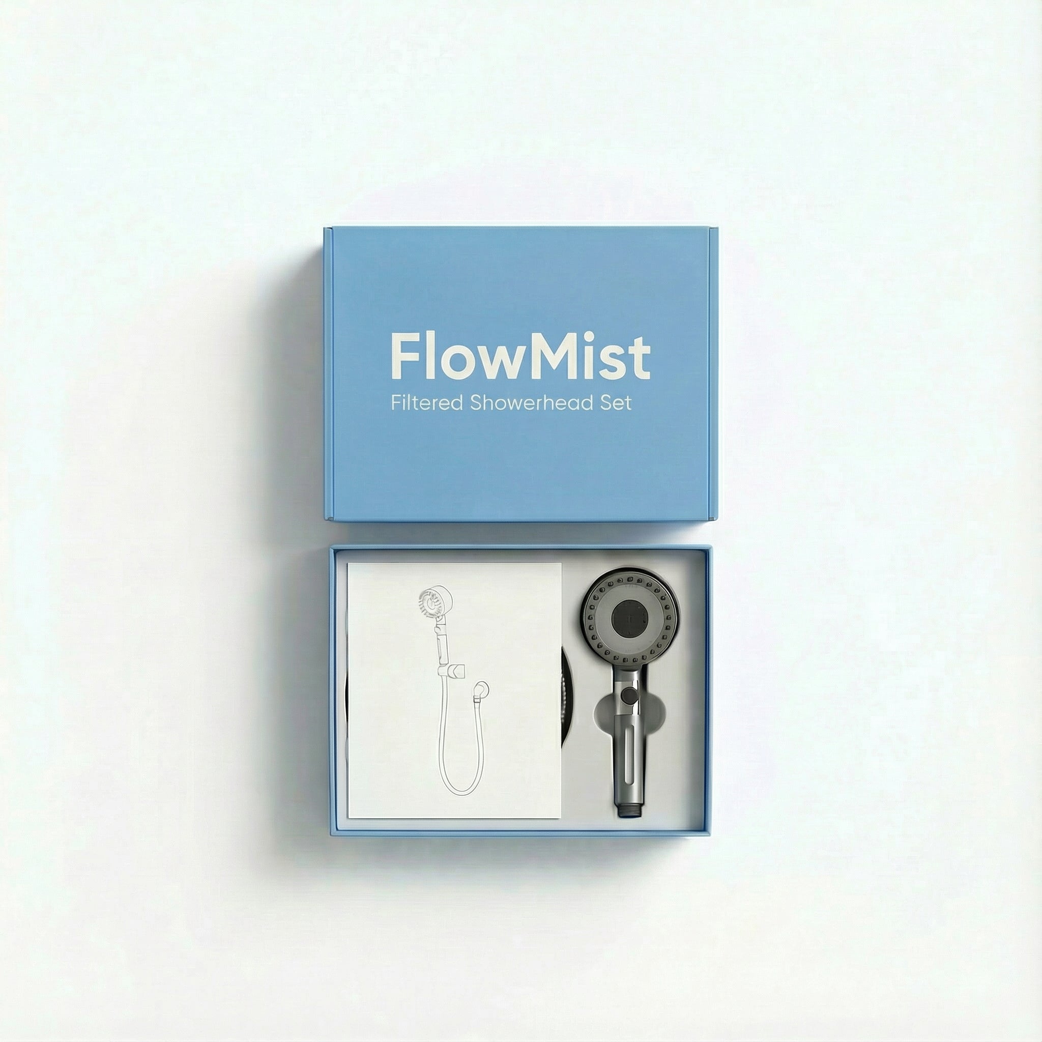 FlowMist filtered showerhead set displayed in an open box. The box contains the showerhead, hose, wall mount, and 5 filters, with a simple instruction manual shown inside. The box is sleek and minimalist, showcasing a premium design.
