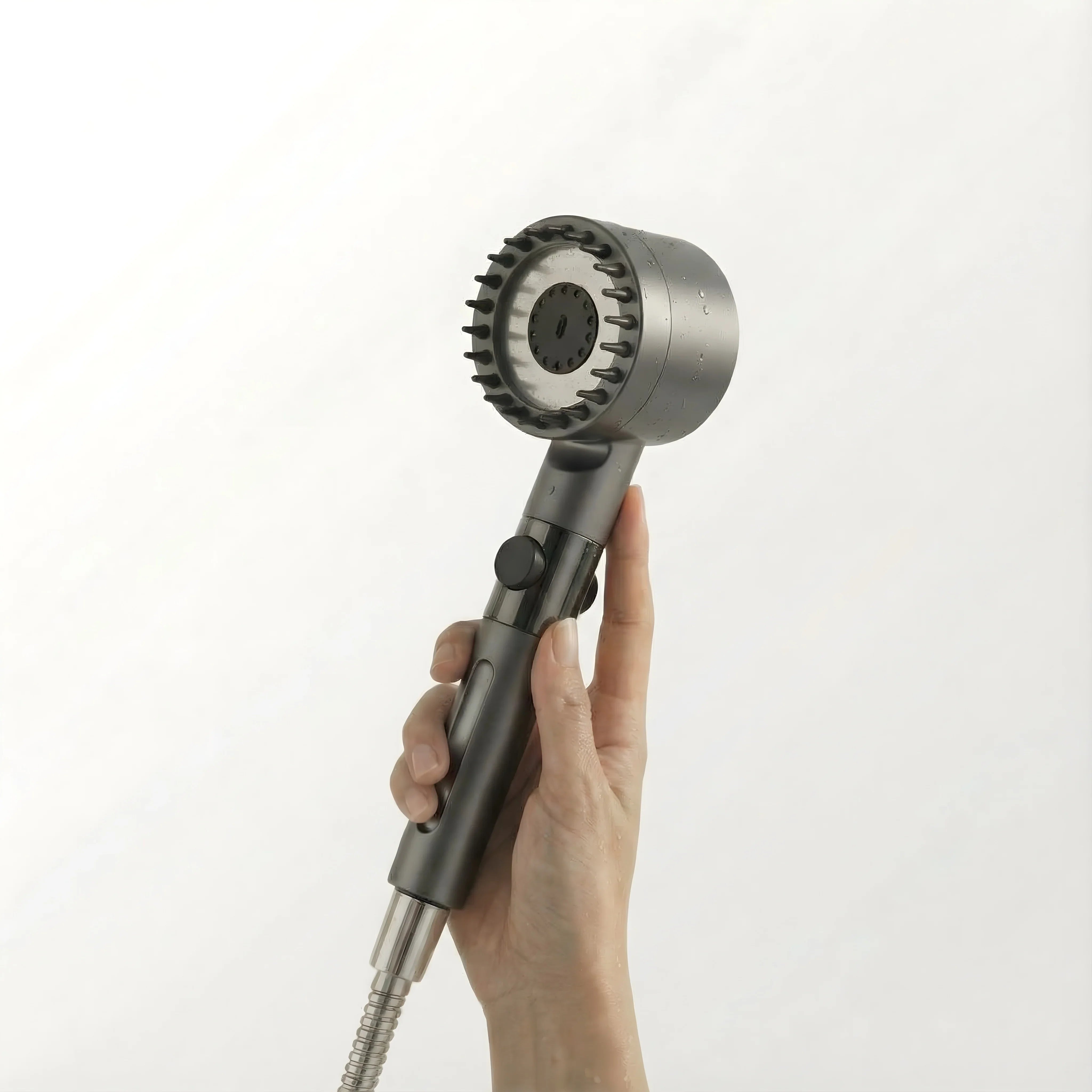 A high-quality, sleek FlowMist filtered showerhead held in hand, showcasing the modern design with a stainless steel finish and water spray nozzle