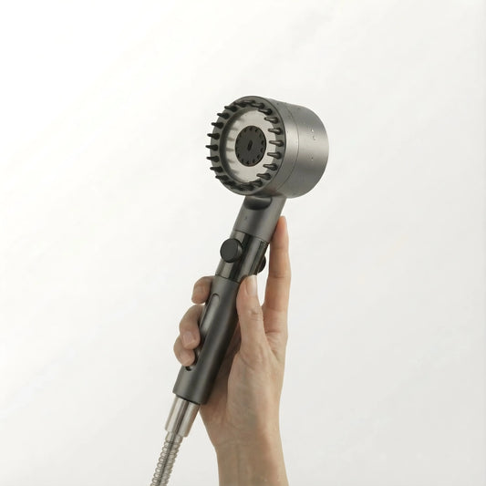 A high-quality, sleek FlowMist filtered showerhead held in hand, showcasing the modern design with a stainless steel finish and water spray nozzle